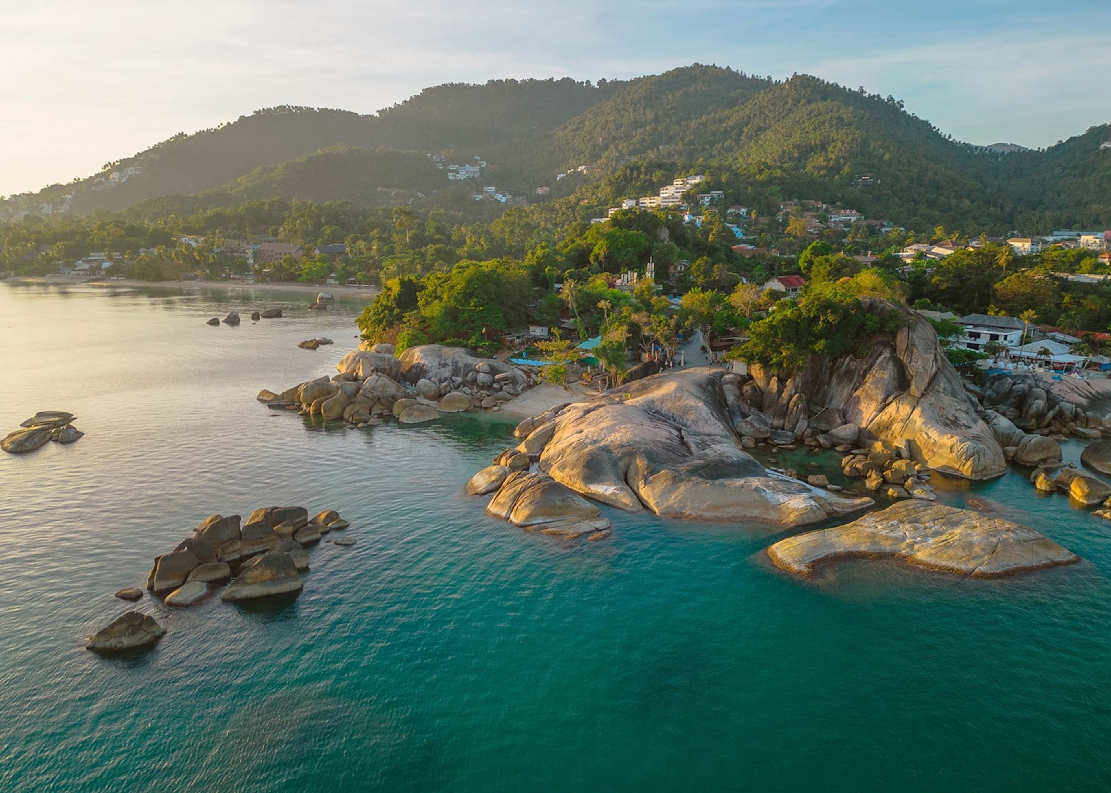 Aerial view of a rocky cove and hillside buildings in Koh Samui